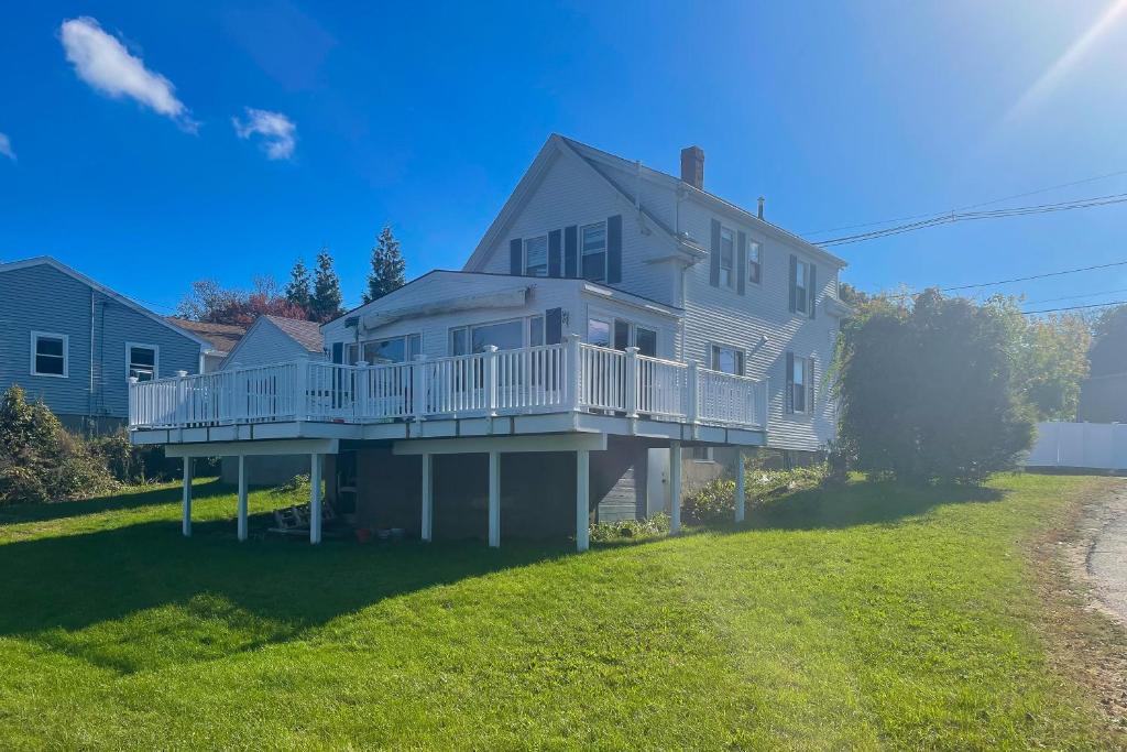a large white house with a large yard at Goat Hill Cottage in Beverly