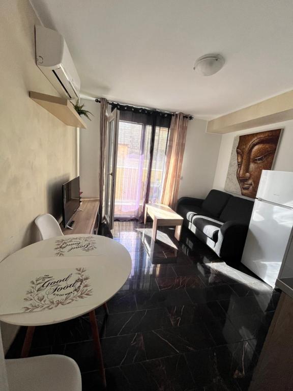 a living room with a table and a couch at Edificio Sofia in Las Galletas