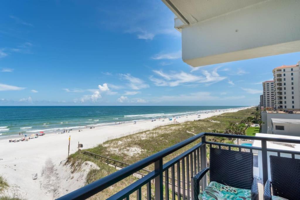 a balcony with a view of the beach at Sandpiper Oceanfront 5C in Jacksonville Beach