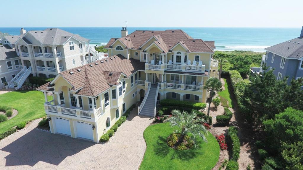an aerial view of a large house with the ocean at PI209, Ritz Palm- Oceanfront, 9 BRs, LUXURY, ELEV, Pool, Rec Rm, Theater Rm, Prv Bch wwy in Sanderling