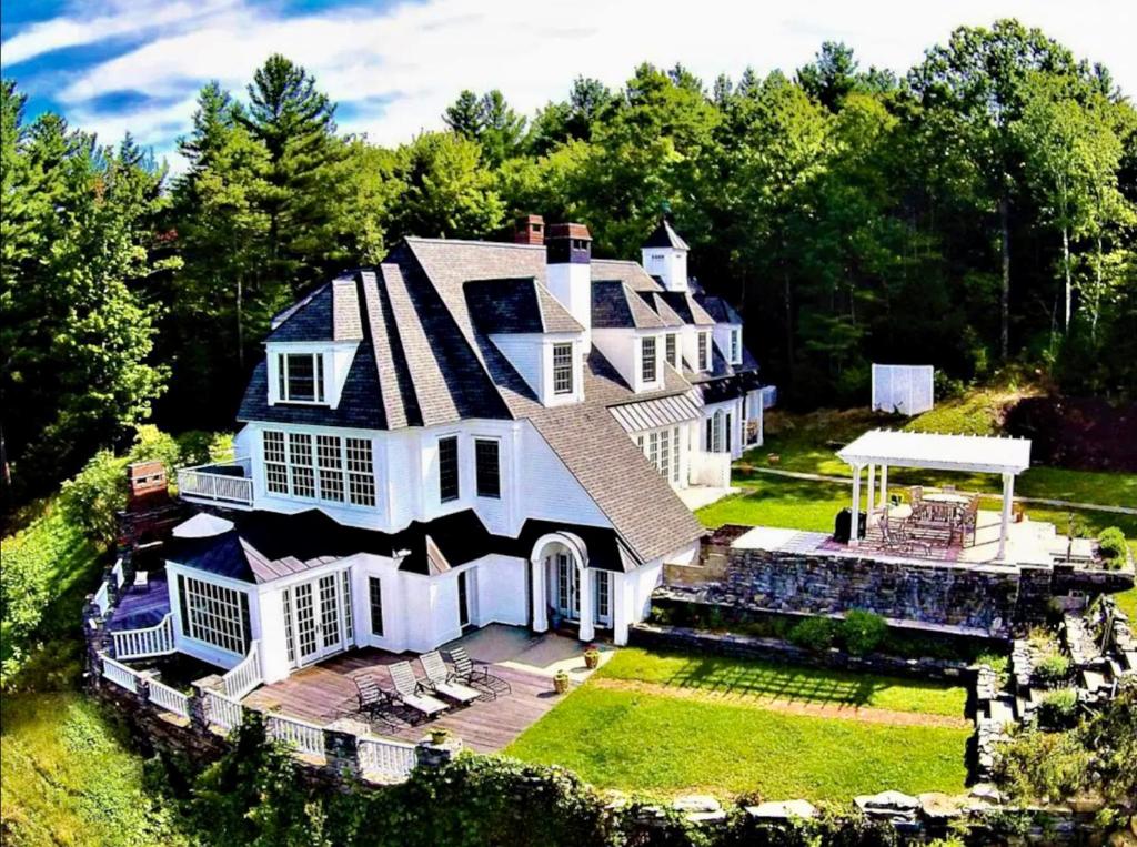 an aerial view of a large white house at Adams Hill House Retreat - Artist-Architect's Estate, Newfane Vermont in Newfane