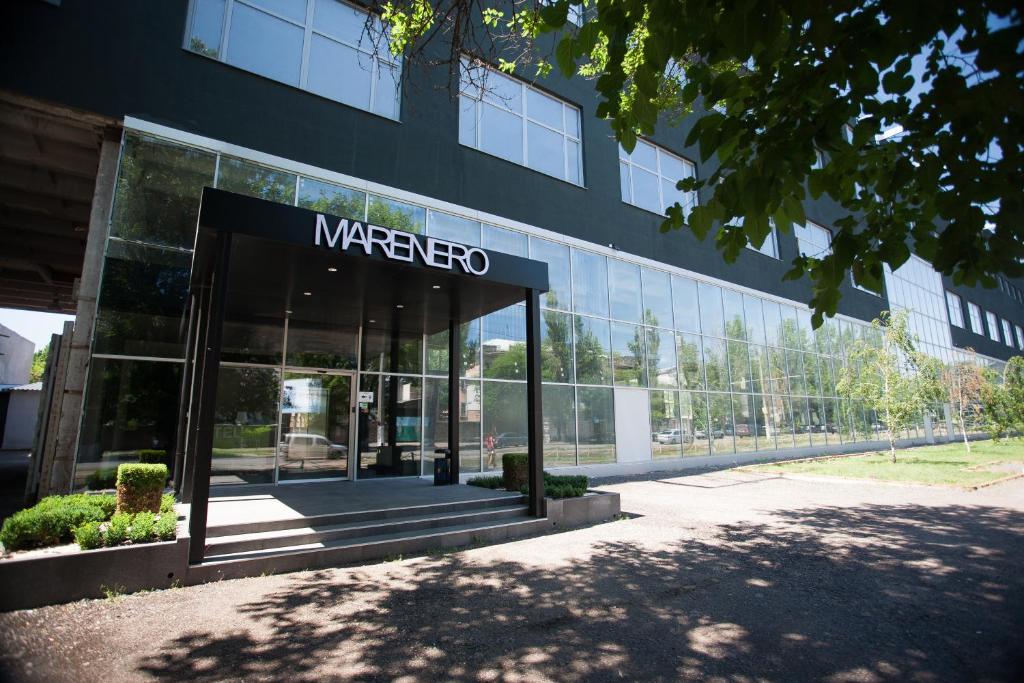 a large glass building with a marco sign on it at Hotel Marenero in Odesa