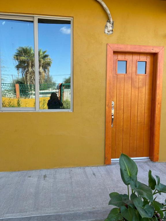 ein orangefarbenes Gebäude mit einer Tür und einem Fenster in der Unterkunft Condominio puerto peñasco 2 in Puerto Peñasco