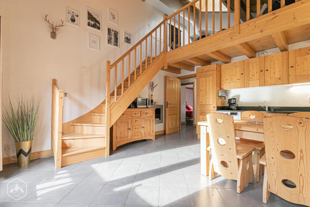 a kitchen with a wooden staircase and a table at Le Marteen’s appartement pour 6 personnes à Val Cenis in Lanslebourg-Mont-Cenis