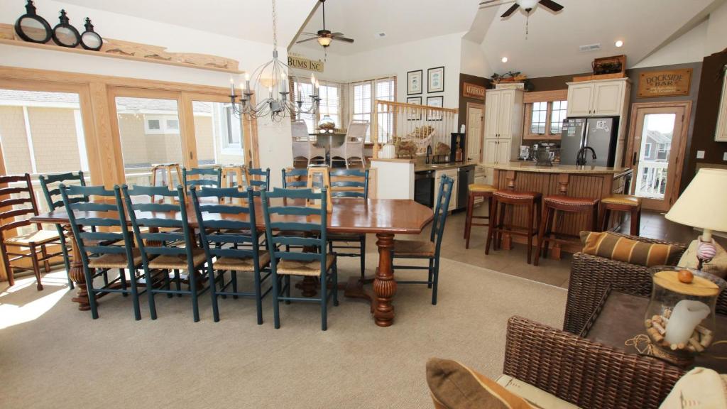 a dining room and kitchen with a table and chairs at PI76, Life of Reilly- Oceanfront, Ocean Views, Private Pool, Private Beach Access, Foosball in Corolla