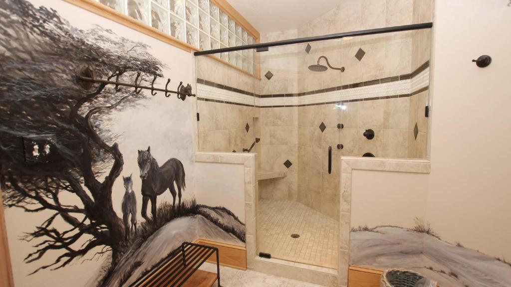 a shower with a horse mural on the wall at PI76, Life of Reilly- Oceanfront, Ocean Views, Private Pool, Private Beach Access, Foosball in Corolla