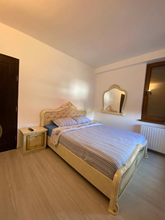 a bedroom with a bed and a mirror on the wall at Apartament 3 camere in Bacău