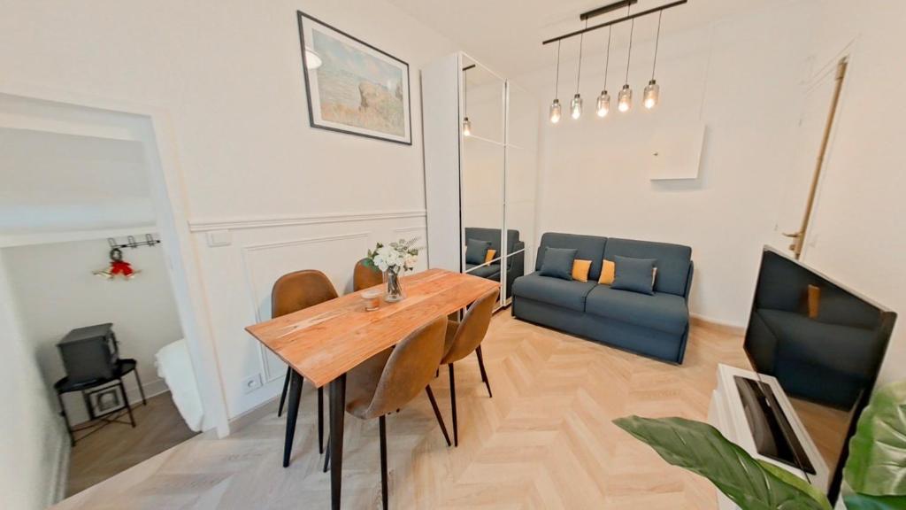 a living room with a wooden table and chairs at Appartement Gare de Lyon in Paris