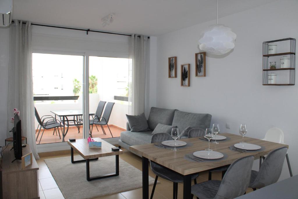 a living room with a table and a couch at Las Terrazas De La Torre Golf Resort - Sueño De Los Hermanos in Roldán