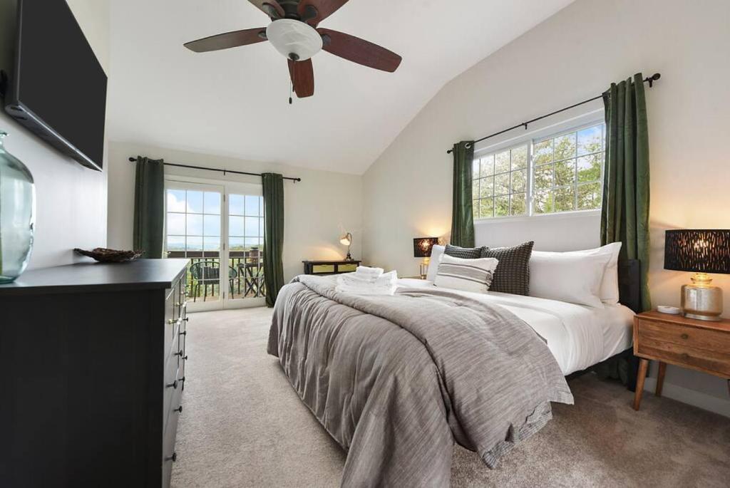 a bedroom with a large bed with a ceiling fan at The Cielo - Ohio River Views in the City in Pittsburgh