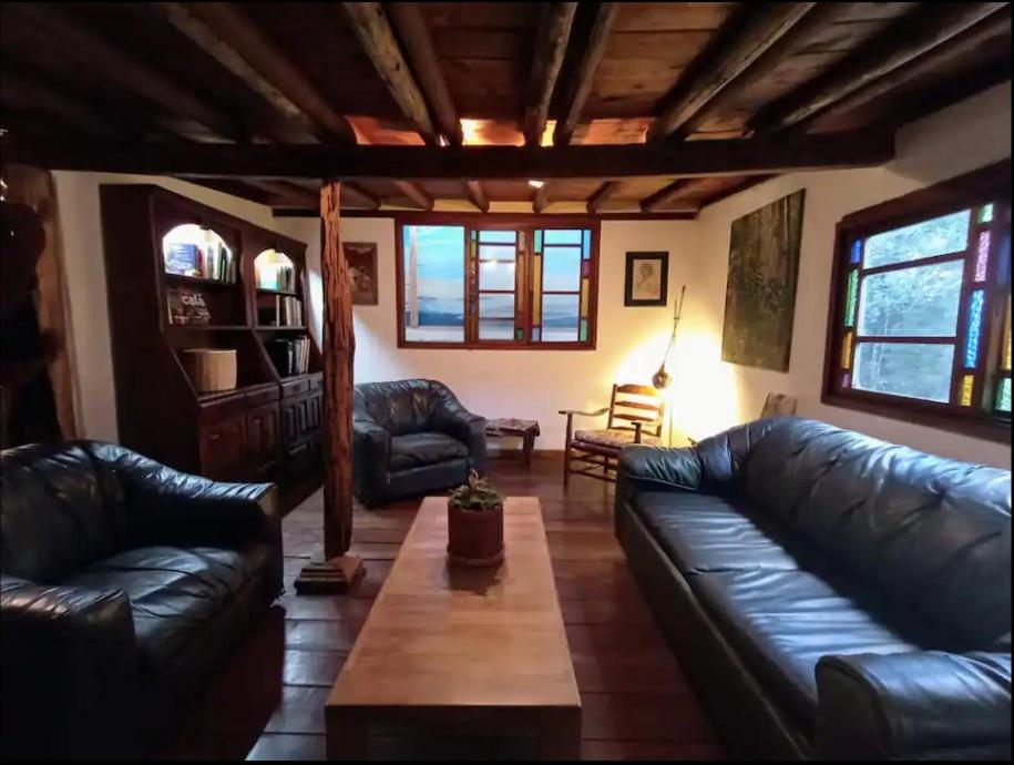 a living room with leather couches and a coffee table at Hobbit House in Envigado