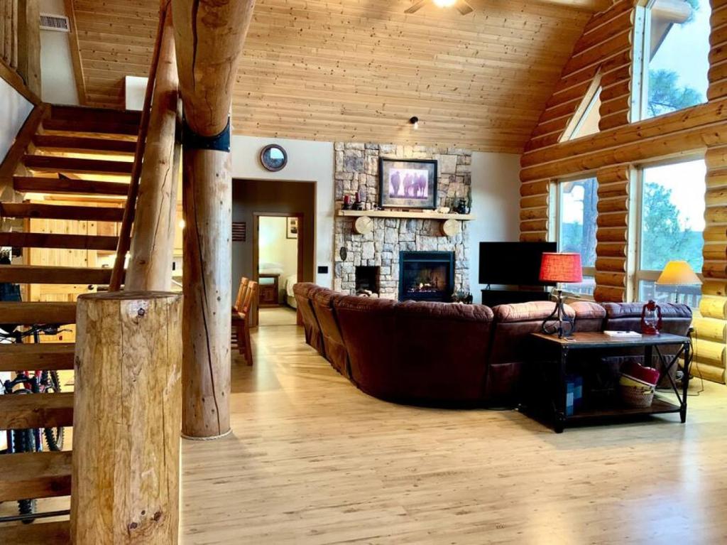 a living room with a couch and a fireplace at Hilltop Chalet-Stunning Views, 3mi from downtown in Prescott