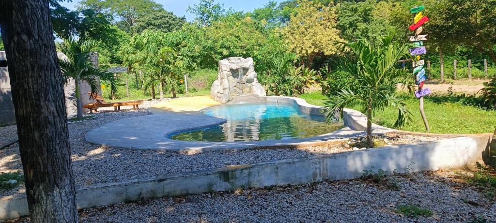 a pool in a backyard with a water slide at Ecohotel Akuaipa in San Juan del Cesar