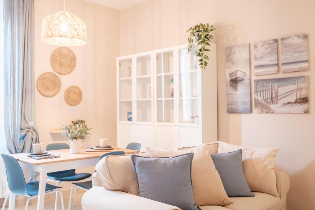 a living room with a couch and a table at Green Coast House 6 in Piombino