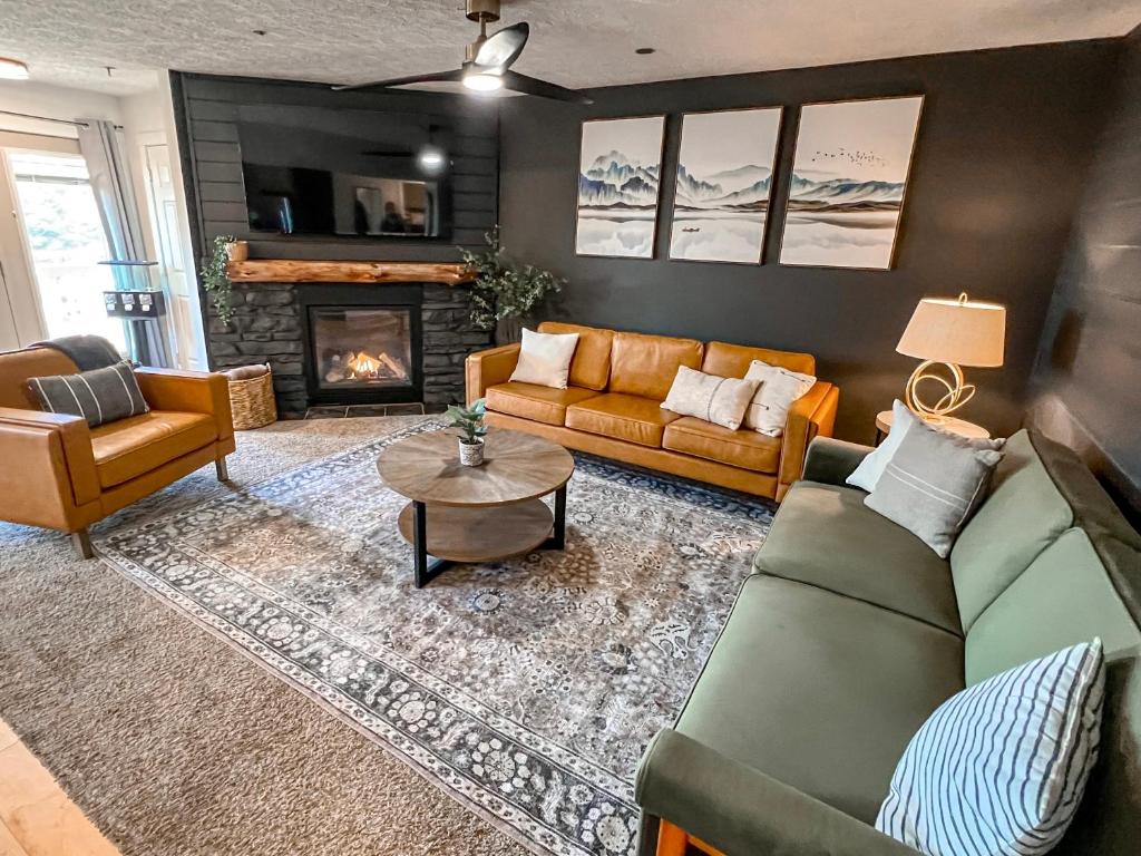 a living room with a couch and a fireplace at Remodeled Summit Condo at Snowshoe - Modern & Cozy in Snowshoe