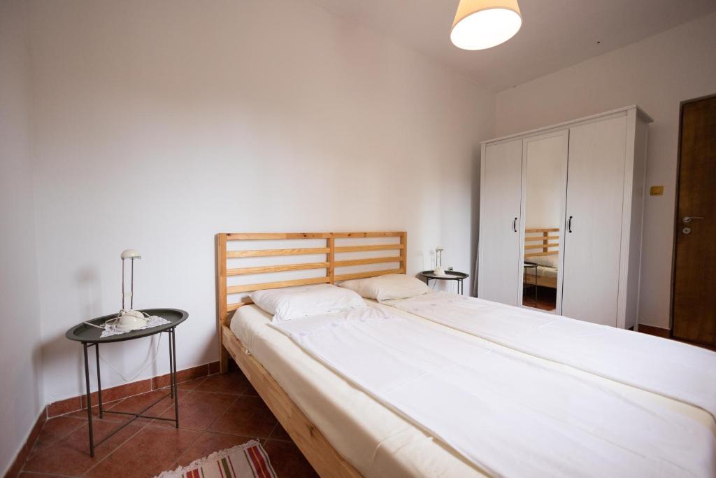 a bedroom with a large white bed in a room at Apartman Marija in Lopar