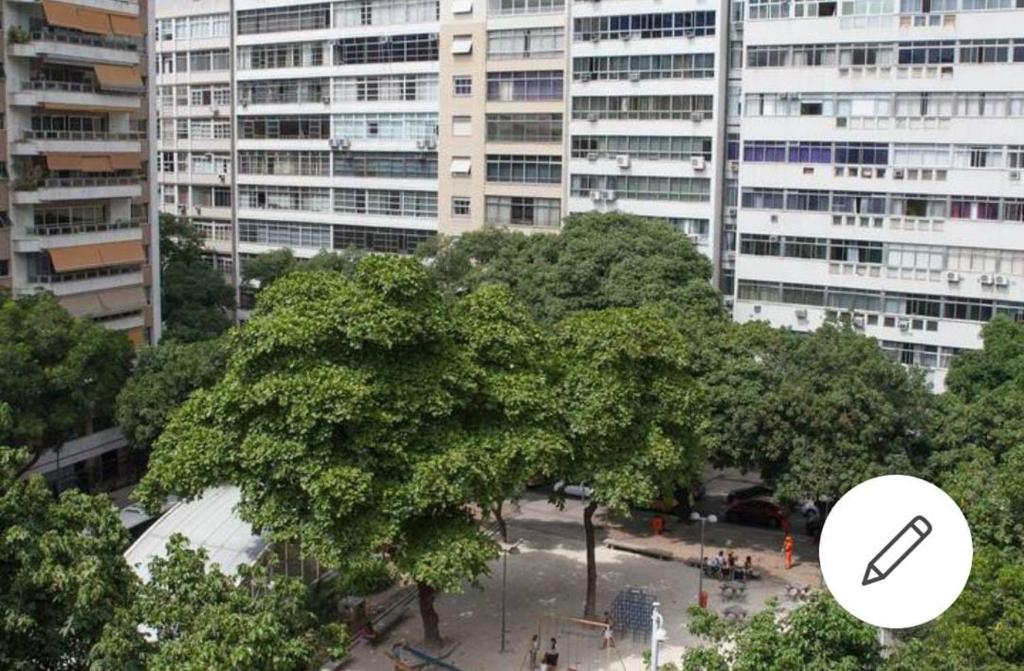 un gran árbol frente a un gran edificio en Localização nobre entre Copa e Lagoa Rodrigo de Freitas, en Río de Janeiro