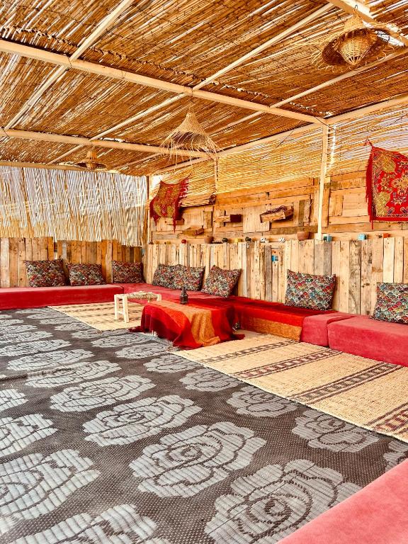 una grande stanza con divani rossi e pareti in legno di K11SURF ad Aourir