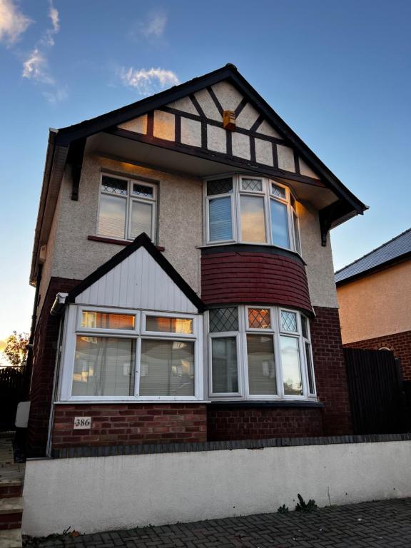 a brick house with large windows on it at Barton BnB 