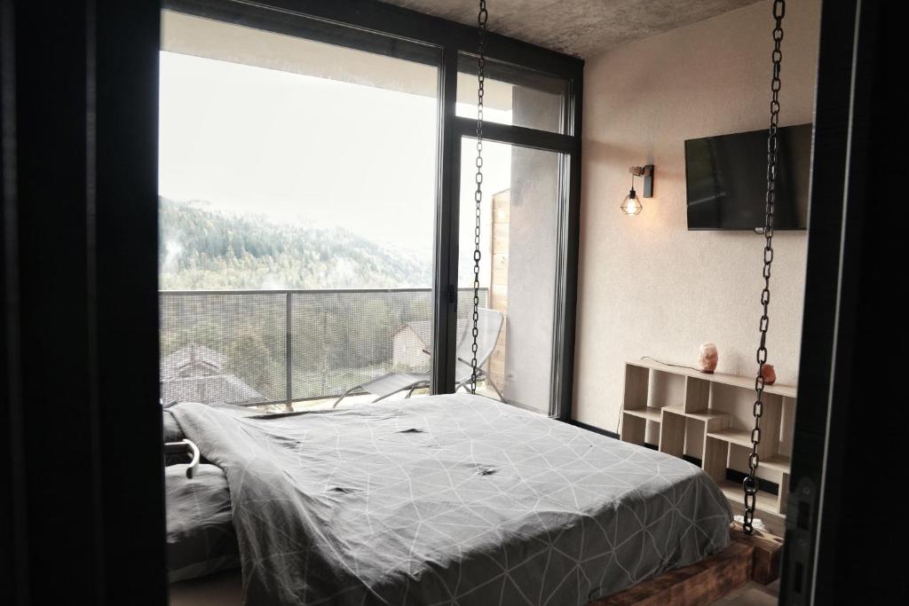 Postel nebo postele na pokoji v ubytování Charmant Appart' du Haut-Jura