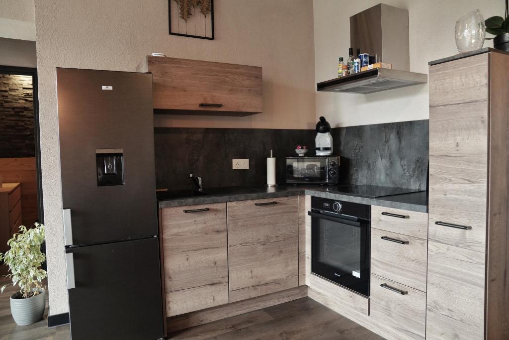 Kuchyň nebo kuchyňský kout v ubytování Charmant Appart' du Haut-Jura