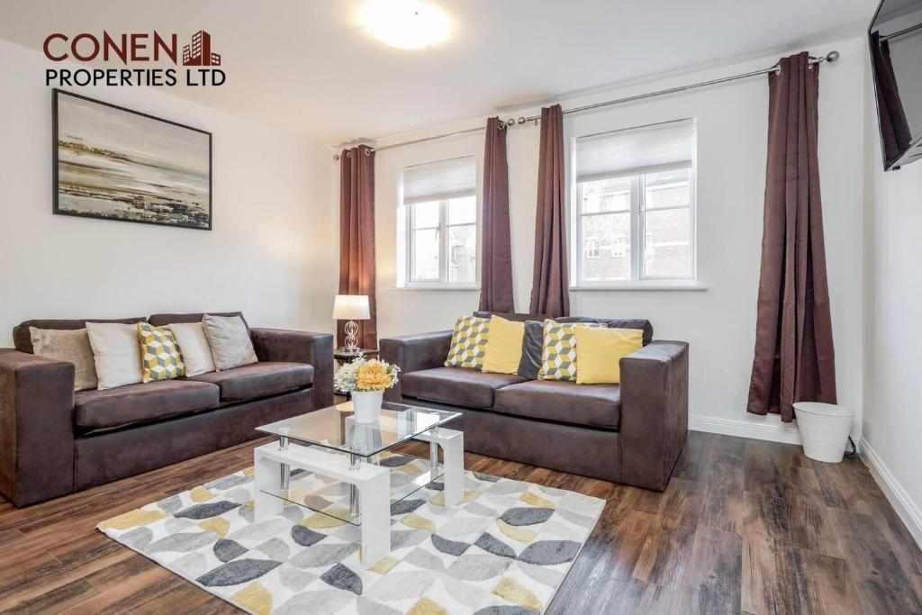 a living room with two couches and a table at Captivating 2-Bed Apartment in Grays in West Thurrock