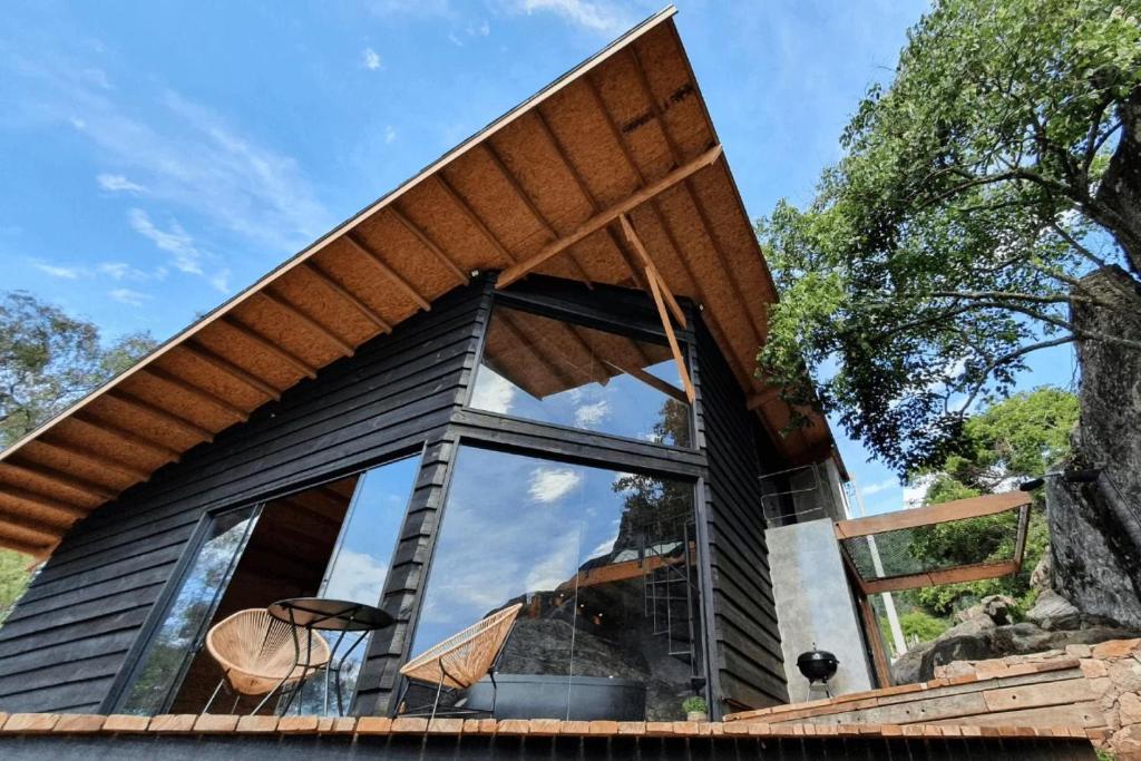 a modern house with a large window at Cabana Carcará in São Bento do Sapucaí