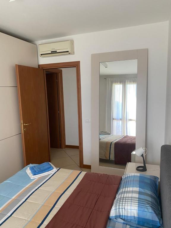 a hotel room with a bed and a mirror at Dante Zara in Borgata Zarattini