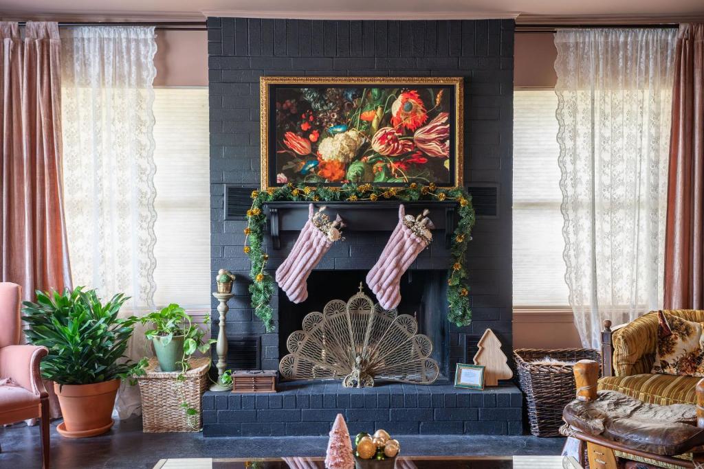 a living room with a fireplace decorated for christmas at Cozy Family-Friendly Getaway, near Austin in Lockhart