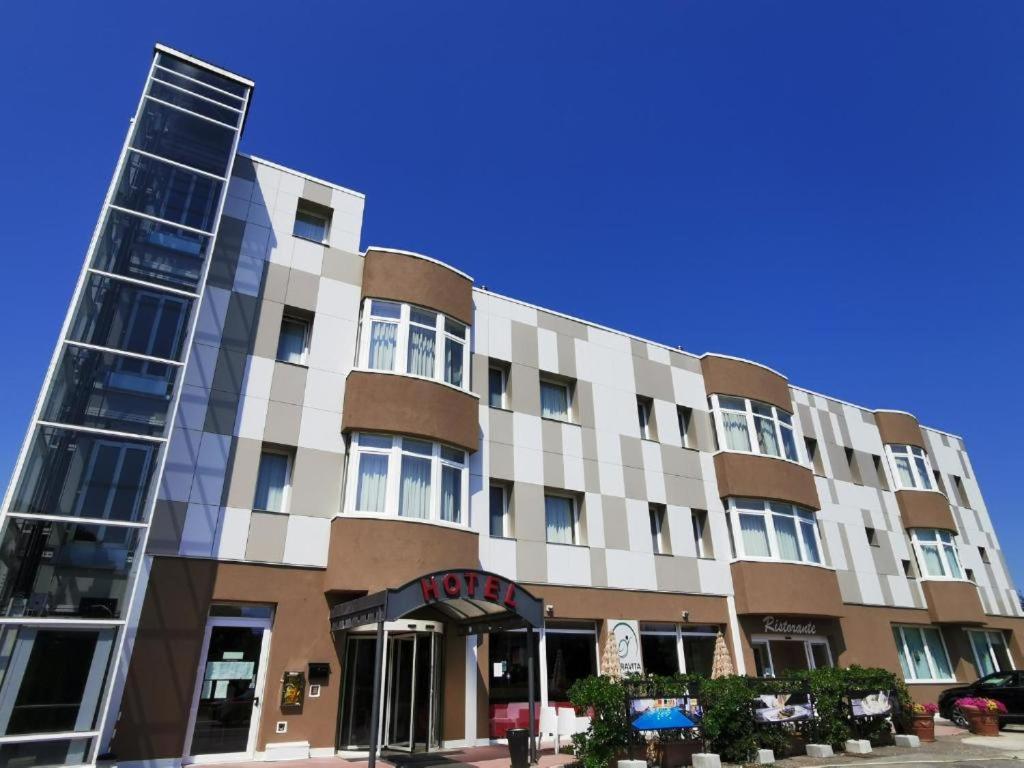 a large building with a sign in front of it at Hotel Formula Int. & Puravita SPA in Rosolina