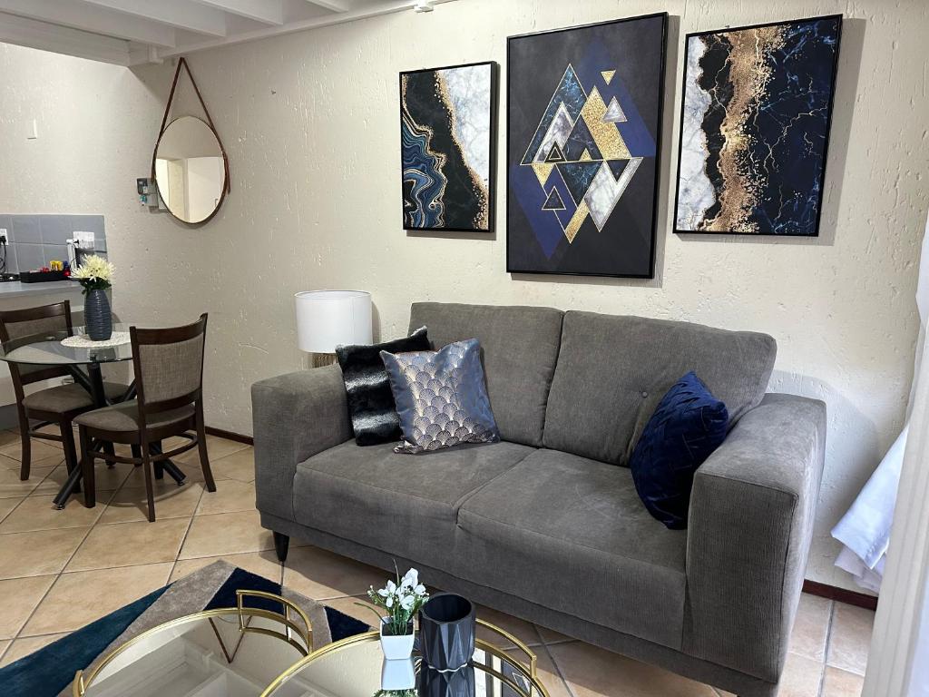 a living room with a couch and a table at Luxurious Loft Condo in Fourways - A Hotel Experience with a Personal Touch in Sandton