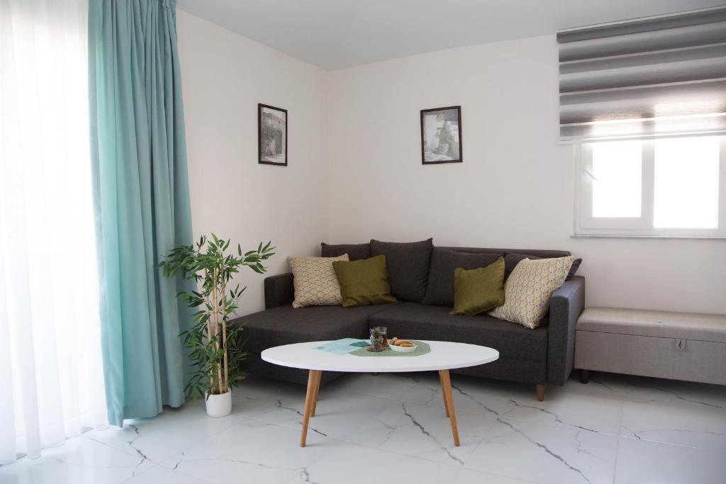 a living room with a couch and a table at Art Life apartments (Olive) in Alanya
