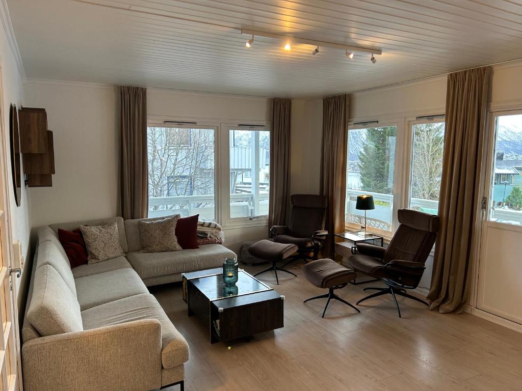 a living room with a couch and a table at Arctic 3 room apartment - Aurora View - Free Parking in Tromsø