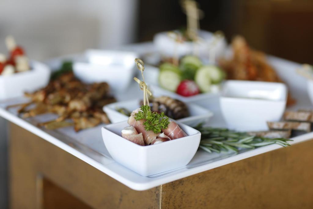 a table with bowls of food on a table at Hotel AVA in Sempach Station