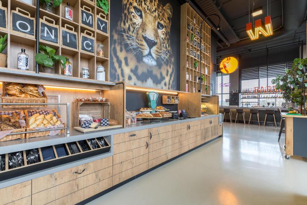 a bakery with a tiger mural on the wall at Leonardo Hotel Groningen in Groningen