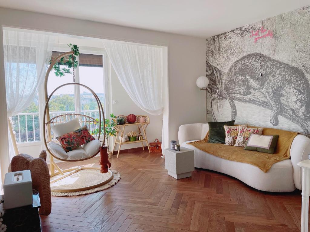 a living room with a white couch and a window at Rose Blossom apartment in Paris in Vanves