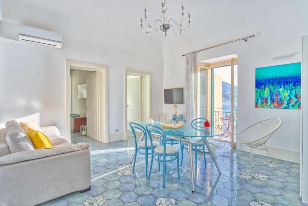 a living room with a glass table and chairs at Devalù casa del mare in Cefalù
