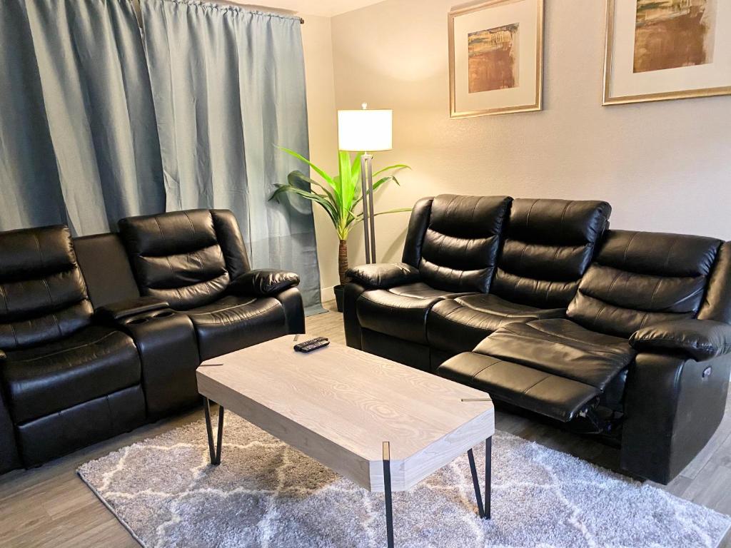 a living room with leather chairs and a table at 3 bedrooms 2 bath close to strip sleep 6 in Las Vegas