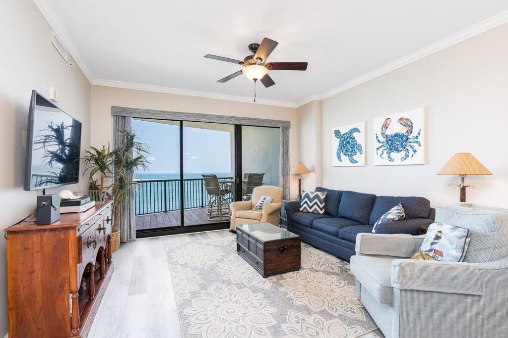 a living room with a couch and a ceiling fan at Grand Pointe Unit 506 in Orange Beach