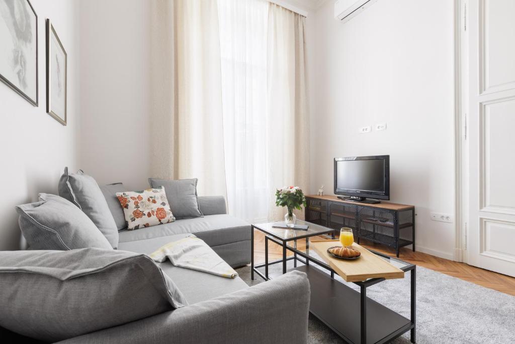 a living room with a couch and a tv at Cozy & 3 minutes from main square - J in Zagreb