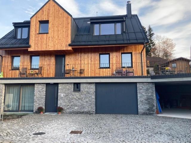 a large wooden house with a black roof at Harrachov 702 in Harrachov