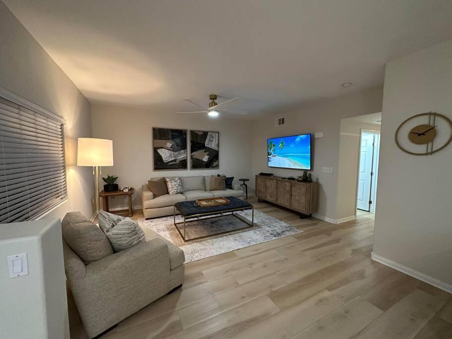 a living room with a couch and a tv at Mesquite Retreat 2 Bd Condo by Cool Properties LLC in Mesquite