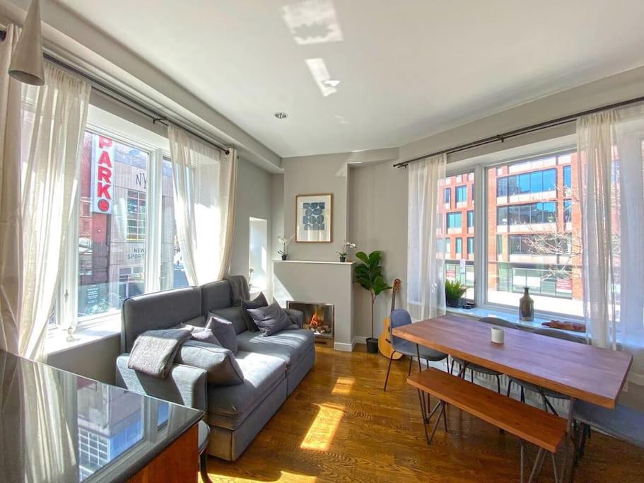 a living room with a couch and a table at Gorgeous Three Bedroom West Village Townhouse in New York