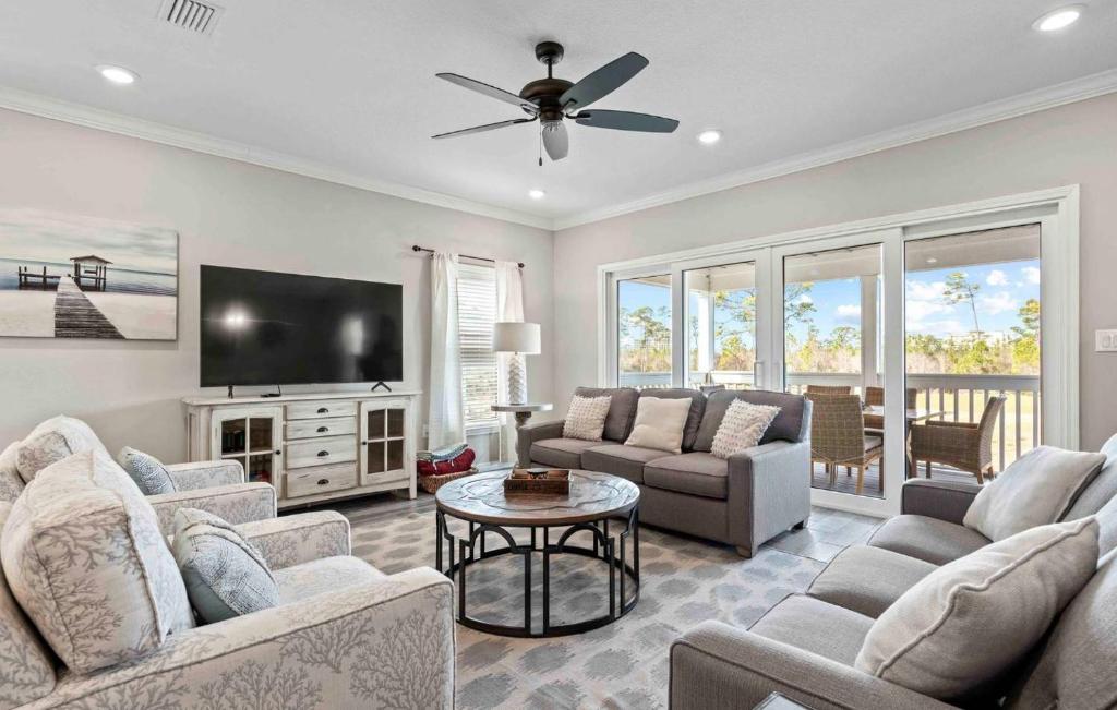 a living room with couches and a flat screen tv at Paradise Key at Lost Key Golf & Beach Club in Pensacola