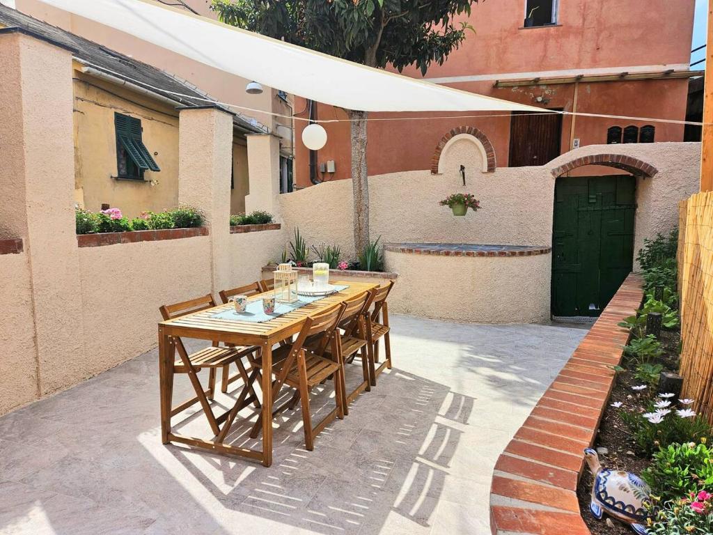 a wooden table with chairs on a patio at Il Giardino di Iris in Genova