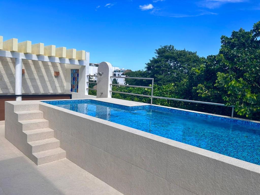 a swimming pool in the backyard of a house at CondoHotel Piedra del Caribe in Puerto Morelos