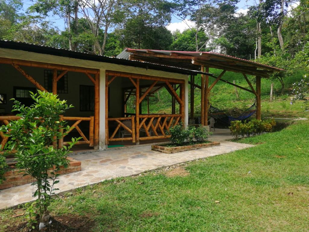 a house with a porch and a deck at Cabaña Campestre de descanso in Melgar