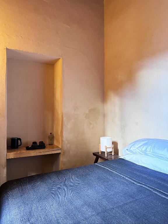 Postel nebo postele na pokoji v ubytování CASA PENUMBRA- Centro Oaxaca