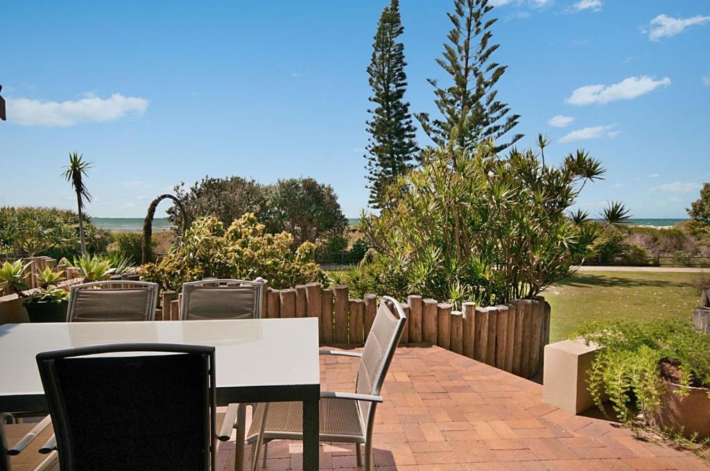 un tavolo bianco e sedie su un patio in mattoni di Karingal 4 a Lennox Head