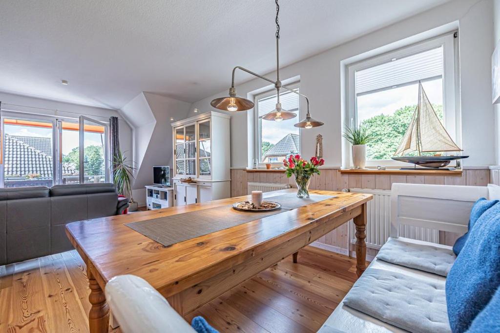 a kitchen and living room with a wooden table at Oberdeck in Maasholm
